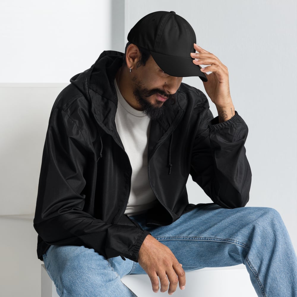 Man wearing custom embroidered baseball cap in urban lifestyle, personalized logo hat