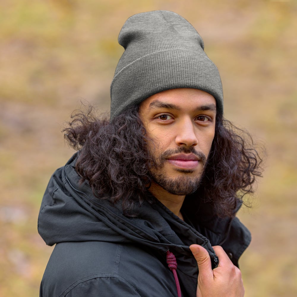 Man wearing custom beanie in outdoor lifestyle setting, personalized logo knit hat for winter