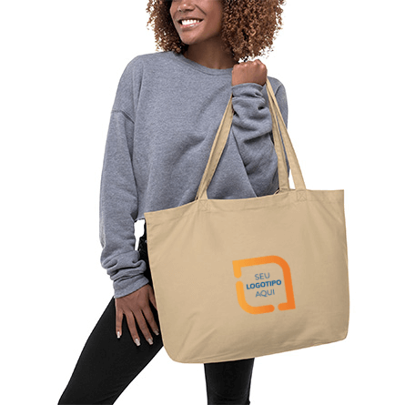 Modelo feminino segurando sacola de lona personalizada com um design de logotipo de amostra