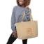 Female model holding custom canvas tote bag with a sample logo design